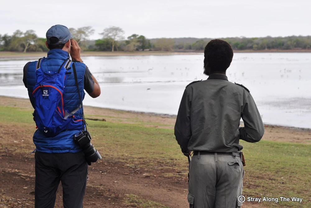 Bevan looking through binoculars at Nyamiti Pan in Ndumo Game Reserve.